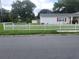Charming house with a white picket fence and well-maintained lawn at 713 W 2Nd St, Lakeland, FL 33805