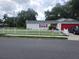 House exterior with red garage door and white picket fence at 713 W 2Nd St, Lakeland, FL 33805