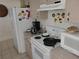 Bright kitchen features electric stove, microwave, and refrigerator at 713 W 2Nd St, Lakeland, FL 33805