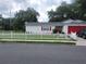 House exterior with red garage door and white picket fence at 713 W 2Nd St, Lakeland, FL 33805