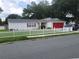 Charming single story home with red garage door and white picket fence at 713 W 2Nd St, Lakeland, FL 33805