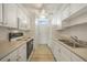 Kitchen features white cabinets, modern appliances, and light flooring at 700 Melrose Ave # K32, Winter Park, FL 32789