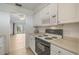 White kitchen with appliances and view to living area at 700 Melrose Ave # K32, Winter Park, FL 32789