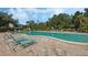 Relaxing kidney-shaped pool surrounded by lush landscaping at 700 Melrose Ave # K32, Winter Park, FL 32789