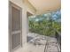 Private balcony with door and scenic wooded views at 700 Melrose Ave # K32, Winter Park, FL 32789