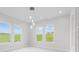 Bright dining room with large windows and modern light fixture at 169 Valencia Ridge Dr, Auburndale, FL 33823