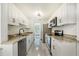 Modern kitchen with white cabinets, granite counters, and stainless steel appliances at 1338 Vassar St, Orlando, FL 32804
