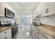 Renovated kitchen featuring stainless steel appliances and granite countertops at 1338 Vassar St, Orlando, FL 32804