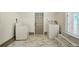 Bright laundry room, featuring washer, dryer, and tiled floors at 1338 Vassar St, Orlando, FL 32804