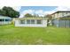 View of the home's backyard with grassy lawn at 1338 Vassar St, Orlando, FL 32804