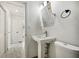 Small bathroom with pedestal sink and toilet at 1338 Vassar St, Orlando, FL 32804