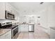 Modern kitchen with stainless steel appliances and granite countertops at 332 Charles Dr, Deland, FL 32724