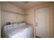 Bright laundry room with washer, dryer, and storage shelving at 823 Camargo Way # 101, Altamonte Springs, FL 32714