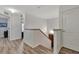 Upstairs hallway with light wood flooring and access to bedrooms at 1624 Hawksbill Ln, Saint Cloud, FL 34771
