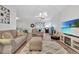 Living room with sectional sofa, recliner, and TV at 1624 Hawksbill Ln, Saint Cloud, FL 34771