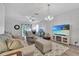Living room with sofa, recliner, and large TV at 1624 Hawksbill Ln, Saint Cloud, FL 34771