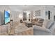 Living room with sofa, armchair, and large TV at 1624 Hawksbill Ln, Saint Cloud, FL 34771