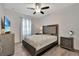 Spacious bedroom with a ceiling fan, large bed, and gray dresser at 1624 Hawksbill Ln, Saint Cloud, FL 34771