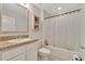Clean bathroom with a tub, white vanity, and large mirror at 1624 Hawksbill Ln, Saint Cloud, FL 34771