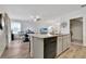 Open concept kitchen with granite island, hardwood floors, and dining area at 1624 Hawksbill Ln, Saint Cloud, FL 34771
