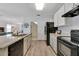 Modern kitchen with granite countertops and black appliances at 1624 Hawksbill Ln, Saint Cloud, FL 34771
