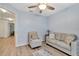 Light and airy living room with a loveseat, armchair, and hardwood floors at 1624 Hawksbill Ln, Saint Cloud, FL 34771