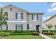 Two-story house with brown shutters and landscaping at 1624 Hawksbill Ln, Saint Cloud, FL 34771