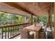 Enjoy a relaxing view from this back porch, featuring a wooden table and chairs at 1205 Sutton Trl, Geneva, FL 32732