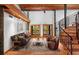 Spacious living room with hardwood floors, leather furniture, and a spiral staircase at 1205 Sutton Trl, Geneva, FL 32732