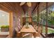 Relaxing screened porch with a long wooden dining table and chairs at 1205 Sutton Trl, Geneva, FL 32732