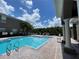 Refreshing community pool with lounge chairs at 10420 Kiplinger Ln # 238, Orlando, FL 32829