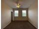 Bright bedroom featuring two windows and a ceiling fan at 10420 Kiplinger Ln # 238, Orlando, FL 32829