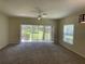 Living room with sliding glass doors opening to a patio and backyard at 10420 Kiplinger Ln # 238, Orlando, FL 32829