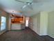 Living room with kitchen view, carpet, ceiling fan and access to other areas at 10420 Kiplinger Ln # 238, Orlando, FL 32829