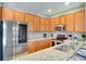 Modern kitchen with stainless steel appliances and light wood cabinets at 491 Las Fuentes Dr, Kissimmee, FL 34746