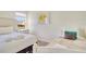Bright bedroom with a queen bed and a twin bed at 491 Las Fuentes Dr, Kissimmee, FL 34746