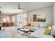 Open living room and dining area with light colored furniture and large windows at 491 Las Fuentes Dr, Kissimmee, FL 34746