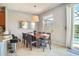 Dining area with large wood table, six chairs, and access to the patio at 491 Las Fuentes Dr, Kissimmee, FL 34746