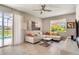 Spacious living room with sectional sofa, large window, and access to a patio at 491 Las Fuentes Dr, Kissimmee, FL 34746