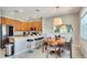 Modern kitchen with wood cabinets, granite countertops, and an island with seating at 491 Las Fuentes Dr, Kissimmee, FL 34746