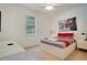Bright bedroom with a large bed, red and gray bedding, and a large window at 491 Las Fuentes Dr, Kissimmee, FL 34746