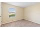 Simple bedroom with window and carpet at 4032 Mountain Chestnut Way, Lakeland, FL 33812