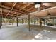 Ample covered parking under house with concrete floor and ceiling fan at 1205 Sutton Trl, Geneva, FL 32732