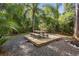 Wooden patio with picnic table nestled in a garden setting at 1205 Sutton Trl, Geneva, FL 32732