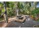 Wooden patio with a picnic table surrounded by tropical plants at 1205 Sutton Trl, Geneva, FL 32732