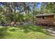 Wooden storage shed nestled in the lush landscaping at 1205 Sutton Trl, Geneva, FL 32732