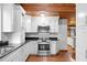 Modern kitchen with white cabinets and granite countertops at 1205 Sutton Trl, Geneva, FL 32732
