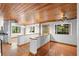 Open living area with wood floors, wood ceilings and large windows at 1205 Sutton Trl, Geneva, FL 32732