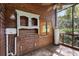 Screened porch with wooden walls, ceiling fan, and storage cabinet at 1205 Sutton Trl, Geneva, FL 32732
