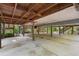 Open parking area under home with concrete floor at 1205 Sutton Trl, Geneva, FL 32732